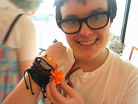 Me wearing and showing off the Charizard bracelet.