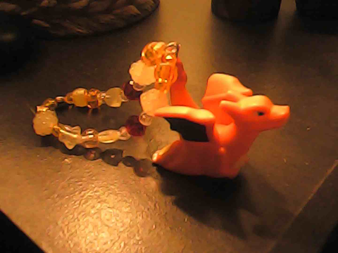 The Charizard bracelet sitting down on its own.